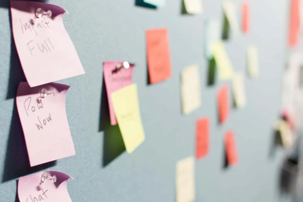 multiple color post it notes, tacked to a blue wall-www.everythingabode.com ways-to-get-more-pinterest-traffic
