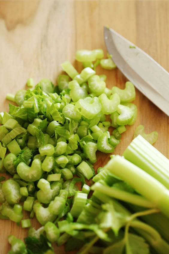 diced celery on kitchen butcher block