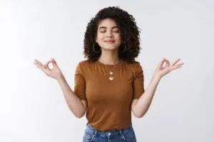 women holding her arms up in meditation pose to relax