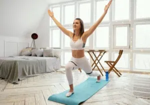 women doing yoga pose on floor in her bedroom for indoor winter hobby