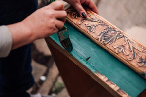 Upcycle Old Things as a indoor hobby to make extra money too, women painting drawer blue