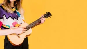 unique indoor hobby girl playing ukulele