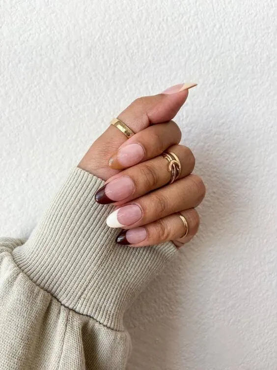 Shades of brown french tip nails.