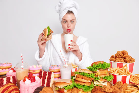 girl eating junk food in robe