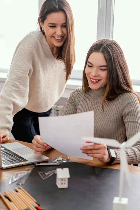 team meeting with two women at the office for motivation