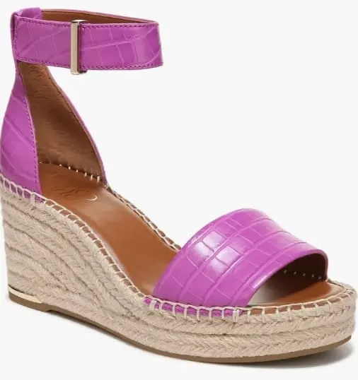 Bold purple croc-effect espadrille wedges with a sleek ankle strap on a simple backdrop