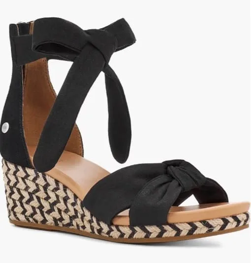 Elegant black suede espadrille wedges with bow detail on a neutral background