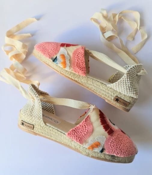 Soft pastel knit espadrille sneakers with cream ribbon laces on a white background