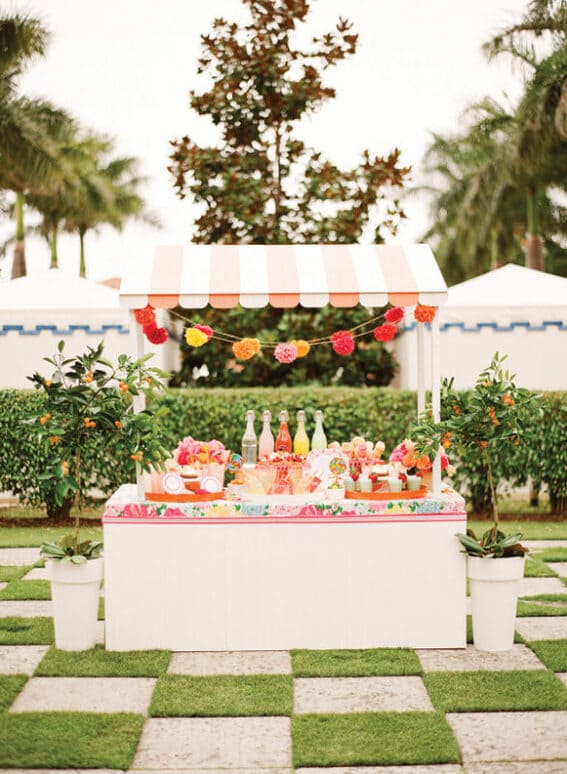 very pretty white outdoor tiki bar with loads of drinks