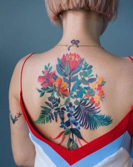 Dramatic, Colorful & Feminine Back Flower Tattoo