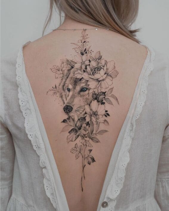 Pretty wolf and flowers back tattoo