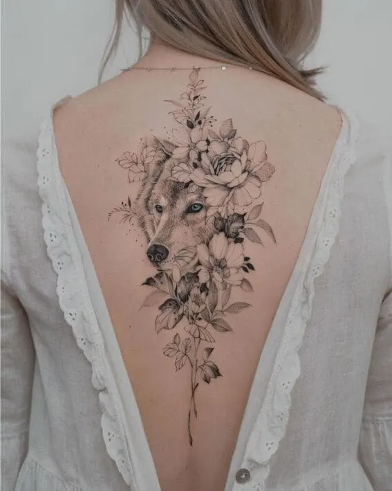 Pretty wolf and flowers back tattoo