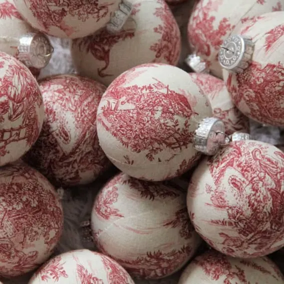 Red toile fabric-covered Christmas baubles.