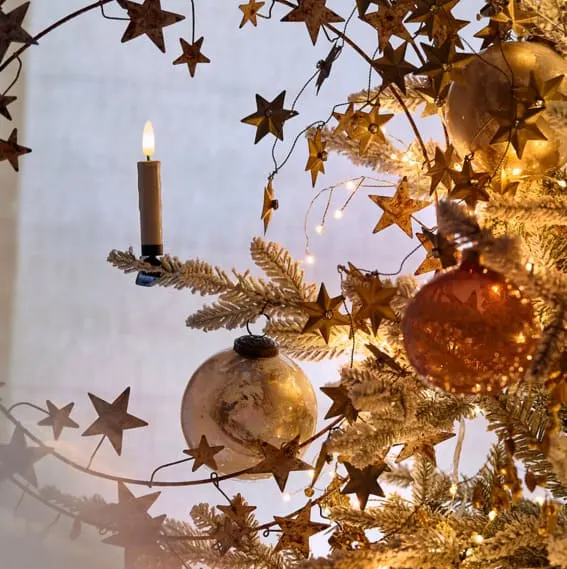 A starry wire wreath with a velvet ribbon.