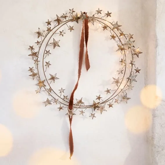 A starry wire wreath with a velvet ribbon.
