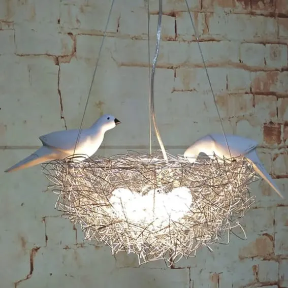 Two ceramic doves in a twig nest hanging light.
