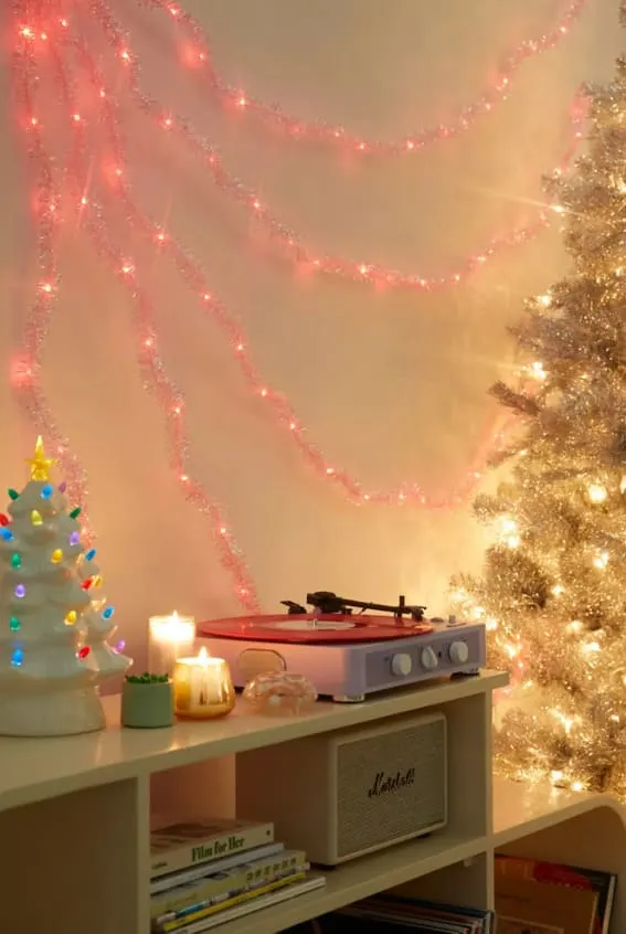 Vintage-inspired pink tinsel garland with glowing lights.