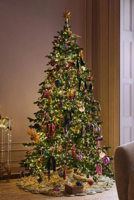 Bohemian chic Christmas tree with eclectic ornaments.
