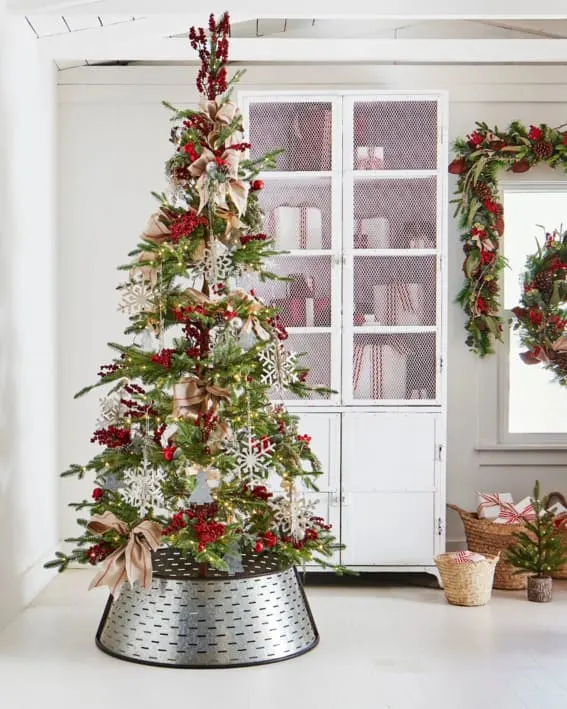 Festive Balsam Hill tree adorned with berries and bows.