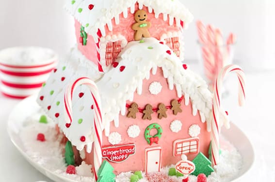 A vibrant gingerbread shop with candy cane pillars and cheerful decorations.