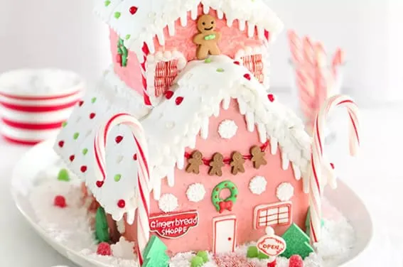 A vibrant gingerbread shop with candy cane pillars and cheerful decorations.