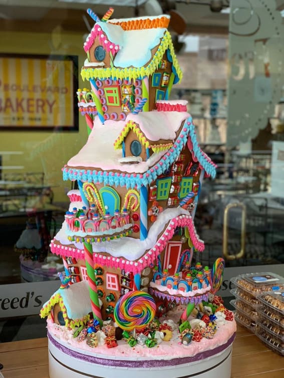 A towering gingerbread display with vibrant candy and whimsical details.