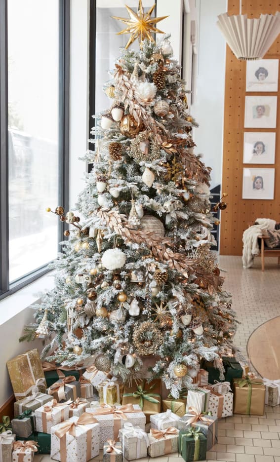Frosted Christmas tree with golden accents by Pottery Barn.