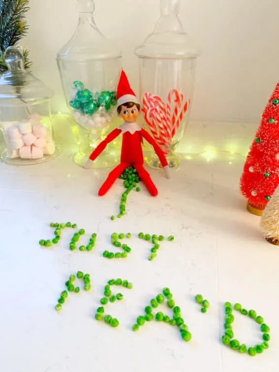 Elf caught crafting a cheeky message with peas.