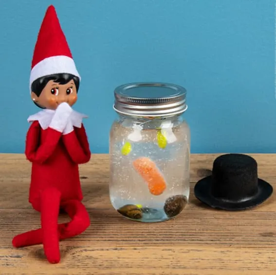 Elf on the Shelf presents a jar with a melted snowman inside.