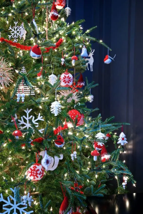 Whimsical Scandinavian-inspired ornaments on a Christmas tree.