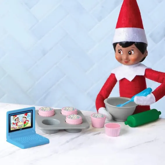 Elf on the Shelf baking cupcakes.