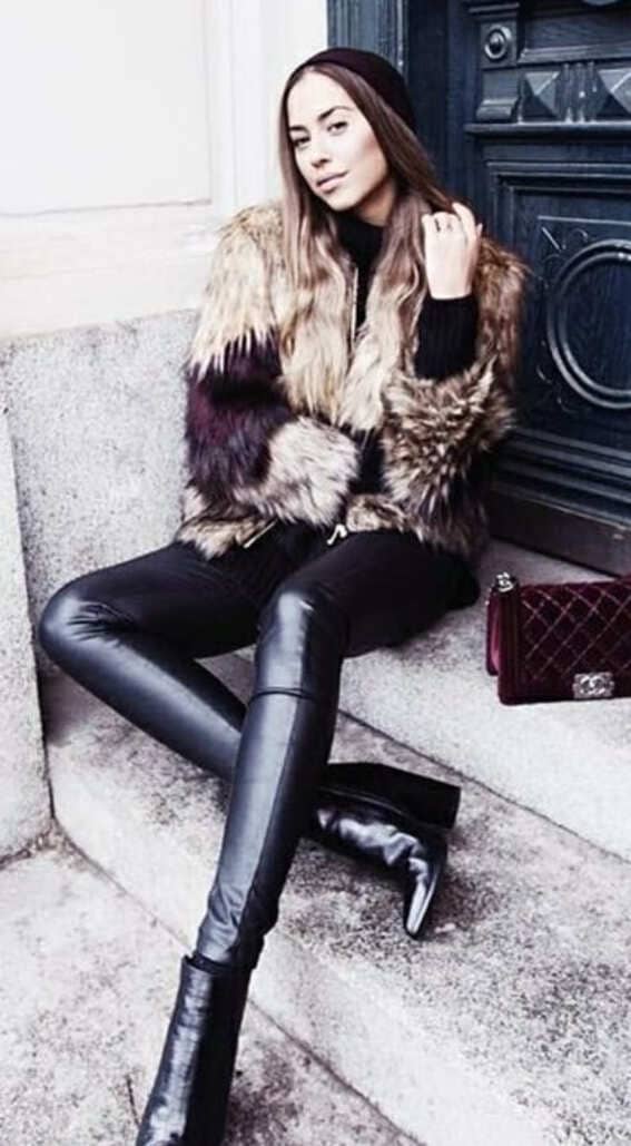 a fur coat teamed with sleek leather leggings and a simple beanie hat