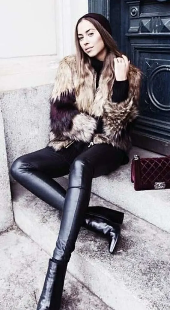 a fur coat teamed with sleek leather leggings and a simple beanie hat