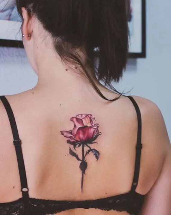 cute dainty rose tattoo on womens inner spine on her back 