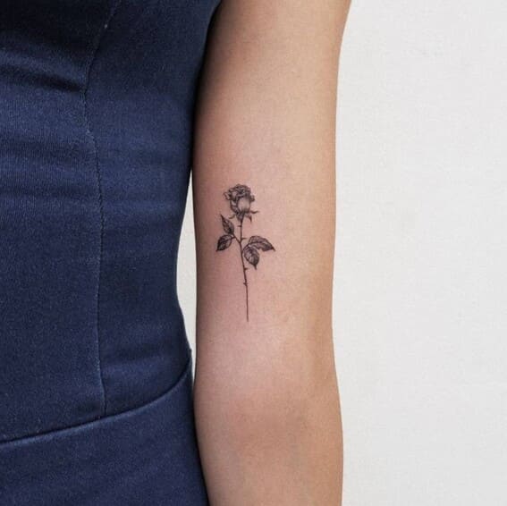 cute small rose tattoo on womens arm