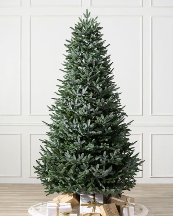 A 6-foot Balsam Hill unlit European Silver Fir artificial Christmas tree, displayed with a backdrop of gifts wrapped in gold and white.
