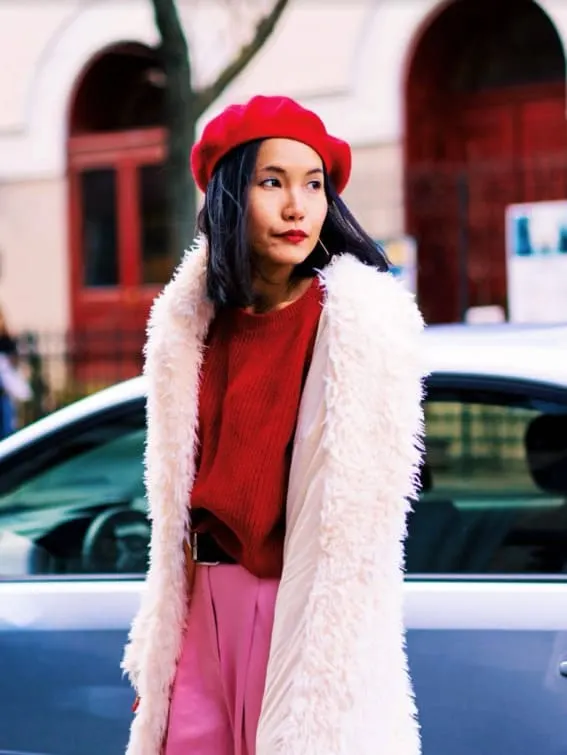 Woman in red and pink holiday outfit with beret