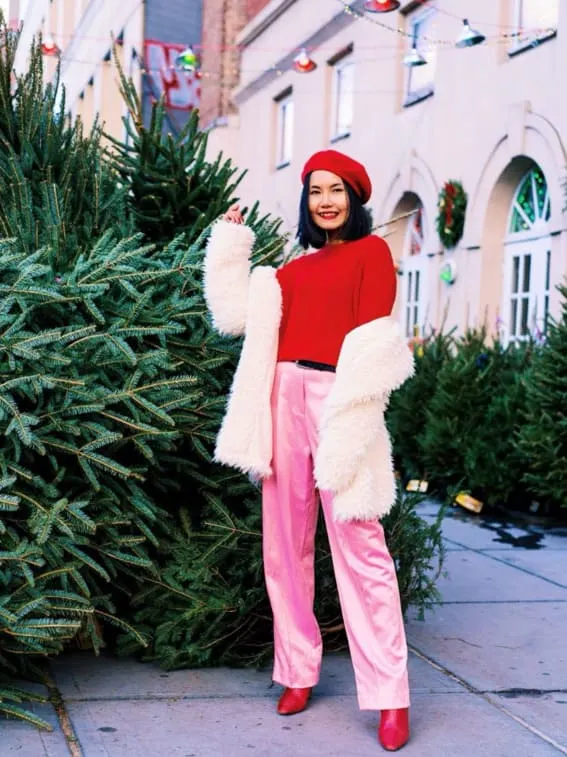Woman in red and pink holiday outfit with beret