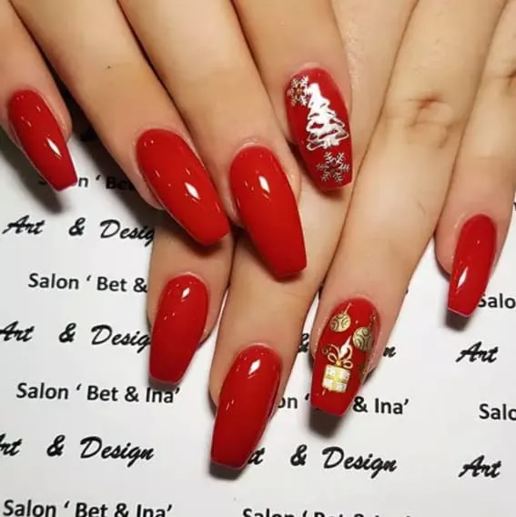 Short nails with vibrant red polish, featuring a Christmas tree and golden bells