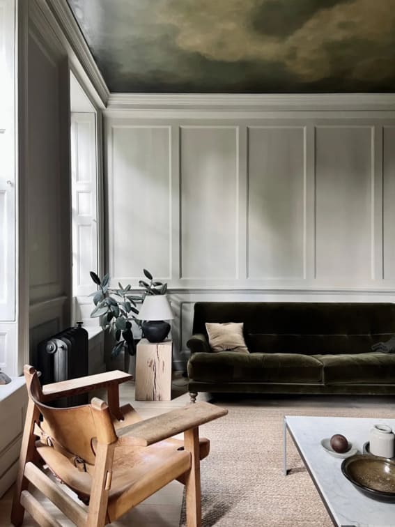 a painted ceiling in dark green in a nice living room