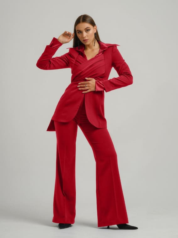 Model in a chic red pantsuit, featured by Wolf & Badger.