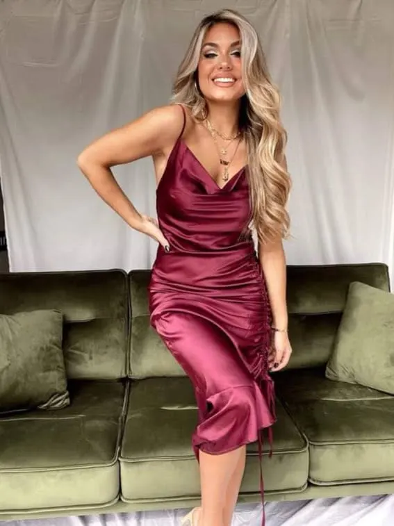 Model in a satin burgundy slip dress