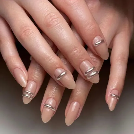 Nude nails with sleek metallic line art.
