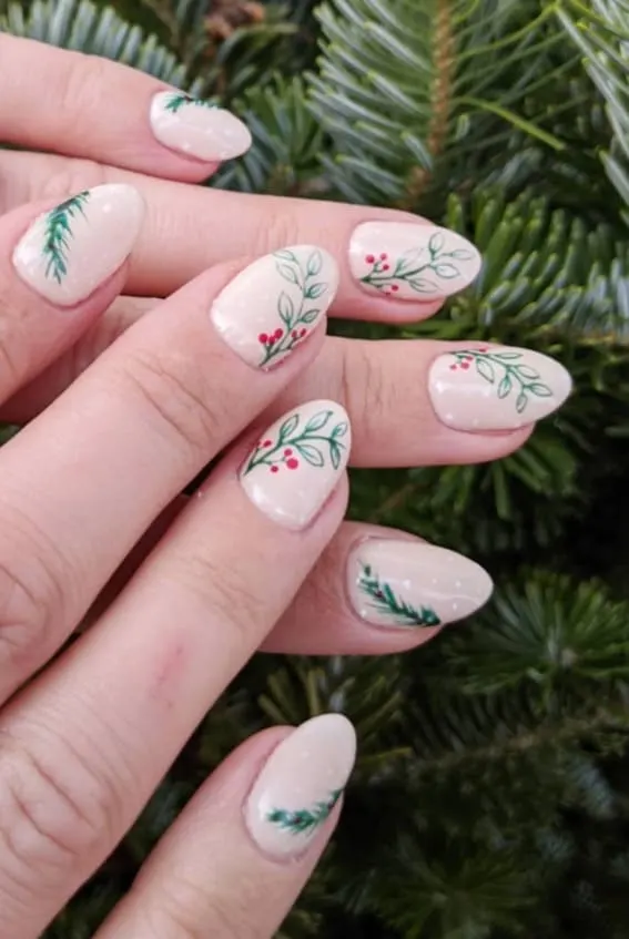 Natural oval nails adorned with hand-painted mistletoe and berry designs.