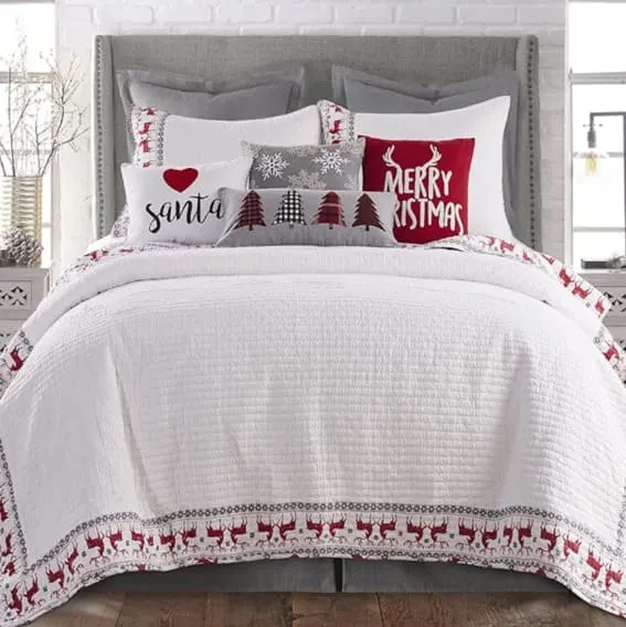 White Christmas quilt set with Rudolph and festive patterns.
