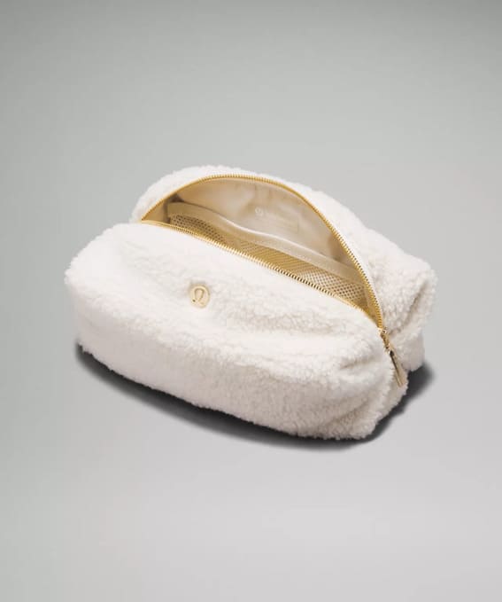 A plush white fleece zippered pouch.