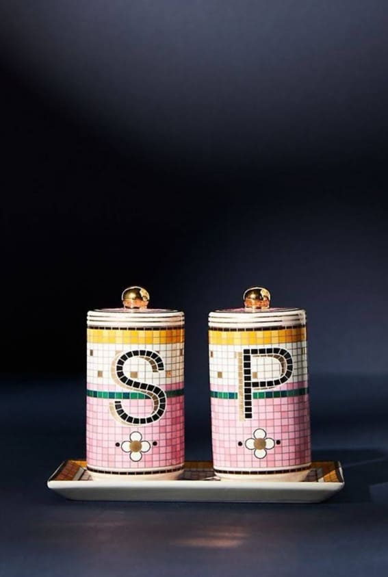 Pastel, mosaic-patterned salt and pepper shakers on a dark background.