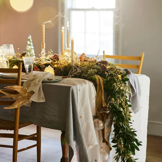 Three twisty taper candles on brass candle holders.