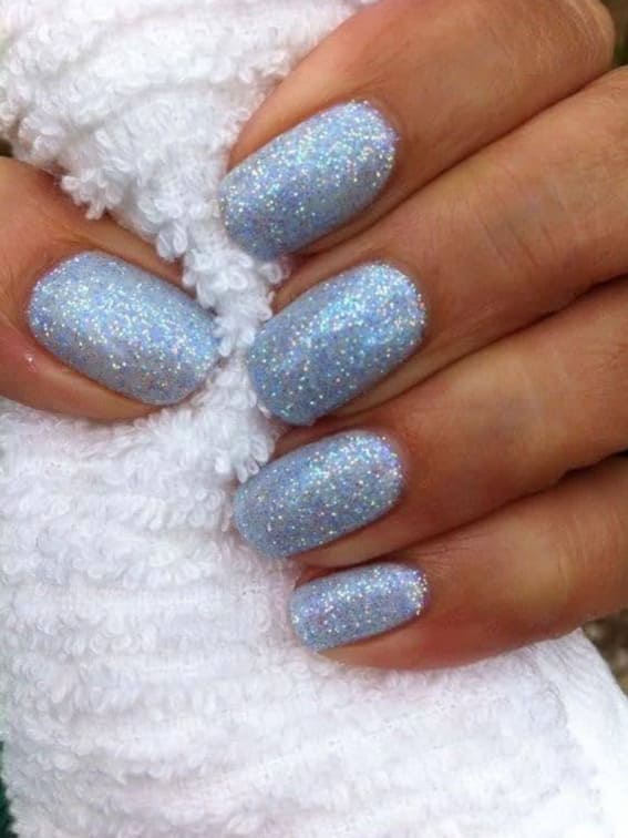 Short nails dusted with icy blue glitter