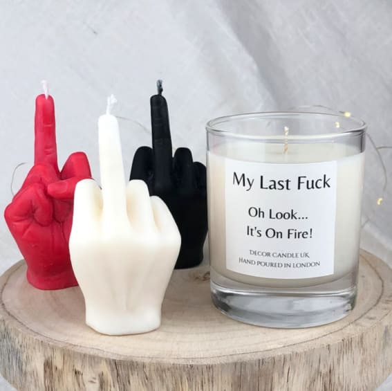 Humorous 'My Last F**' candle, alongside whimsical hand gesture candles.